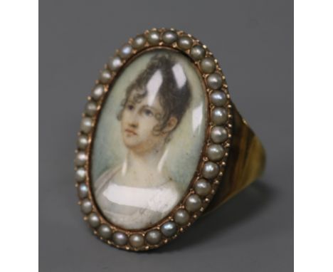 An early 20th century yellow metal and split pearl set portrait miniature ring (adapted), size V.