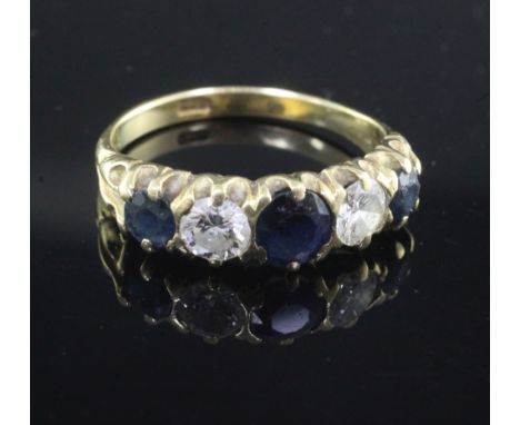 An 18ct gold, sapphire and diamond five stone half hoop ring, set with three round cut sapphires and two diamonds, size Q.