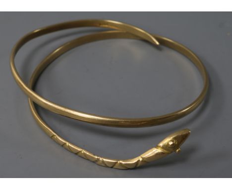 A Middle Eastern yellow metal serpent bangle, 35.9 grams.