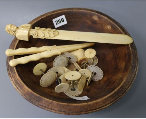 A carved ivory page turner, sewing tools, glove stretchers