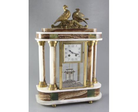 A 1930's polychrome onyx portico mantel clock, surmounted by ormolu doves, the 3.5 inch Arabic dial with blued steel hands, t