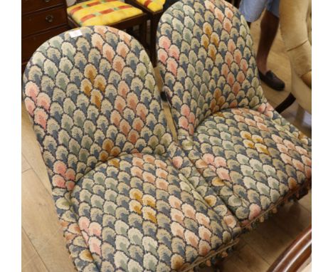 A pair of Victorian rosewood tapestry upholstered nursing chairs