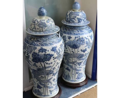 A pair Chinese 20th century blue and white large floor vases and covers, of baluster form, with incised decoration of stylise