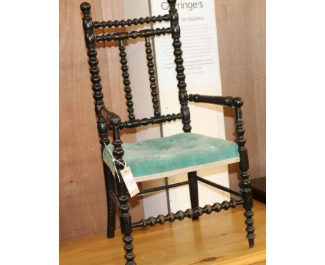A Victorian child's ebonised bobbin turned elbow chair W.36cm