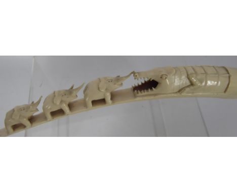 A 19th Century Congolese Carved Ivory Tusk, with carved crocodile and graduated elephants, approx 50 cms.