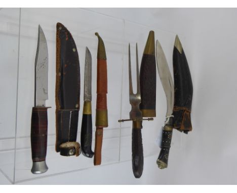 A Miscellaneous Collection of Knives, including Kukri, small Bowie knife, together with a knife and fork set in a carved wood