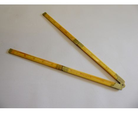 An Ivory Folding Slide Rule, marked R. Fenton  Nov: 1919, extends to 24 inches (61 cms).