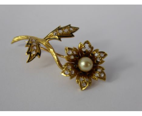 An 18 K Yellow Gold Diamond, Pearl and Enamel Flower Brooch, the brooch set with a pearl approx 6 mm and set with 25 rose cut