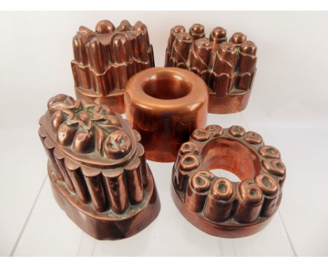 Seven Vintage Copper Jelly Moulds, of various designs, together with a brass jam pan with cast iron handle and a Indian brass