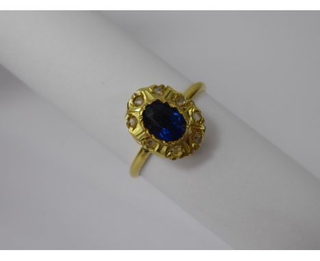 An Antique 18 ct Yellow Gold Hallmarked Royal Blue Sapphire and Diamond Ring, the oval sapphire 7 x 5 mm, eight rose cut dias