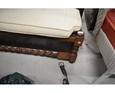 A vintage mahogany foot rest or stool having barley twist legs and stretcher rails