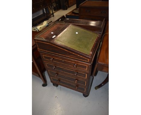 A 19th Century rosewood ladies davenport of compact design having swivel top, and brass gallery and castors