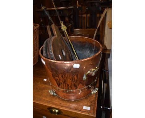 A copper and brass coal bucket, traditional bellows and a selection of fire tools