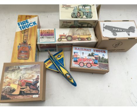A collection of boxed tinplate reproduction clockwork/ battery operated toys, including Retro Steamroller, Aircraft, Tractor 