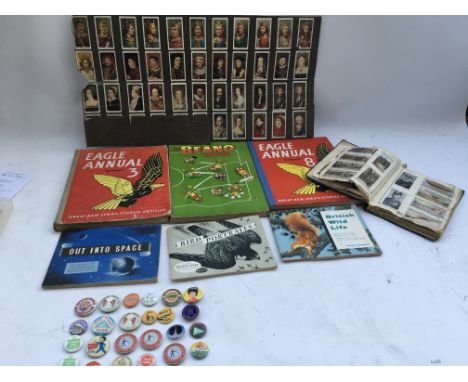 A collection of annuals, Beano and Eagle, Tea and Cigarette cards and a collection of button badges