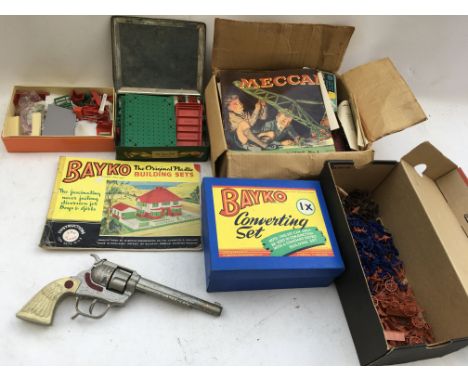 A box containing a collection of Bayko building sets, Meccano , 1:72 scale plastic figures and a Frontier 45 cap gun