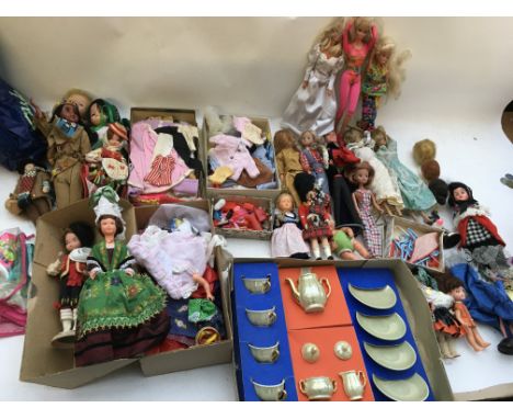 A box containing a collection of dolls and dolls clothes and accessories including Barbie, Patch etc also a Child's tea set