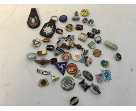 A collection of enamel motorcycle related badges and button badges too, including BSA, Triumph, Ariel etc