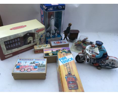 A collection of boxed toys including reproduction tinplate Japanese, a boxed Space shuttle and a Trackside , days gone railwa