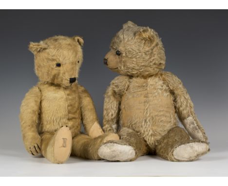 A mid-20th Century mohair teddy bear with later plastic boot button eyes, vertically stitched snout and four claws, and joint