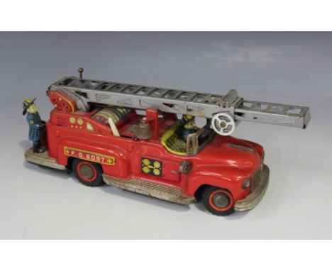 A T.N. tinplate battery powered American style fire engine with extending ladder, driver and three crew, length approx 27cm (