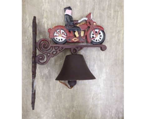 A cast metal door bell, fashioned as a man on a motorbike, on a wall bracket  13''h       RAM