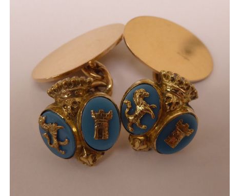 A pair of gold coloured metal and part turquoise coloured enamel tablet and chain cufflinks, decorated with armorial devices 