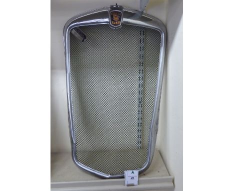 A chromium plated steel radiator cowl for a 'vintage' Morris van; with an attendant identification plate       HSR
