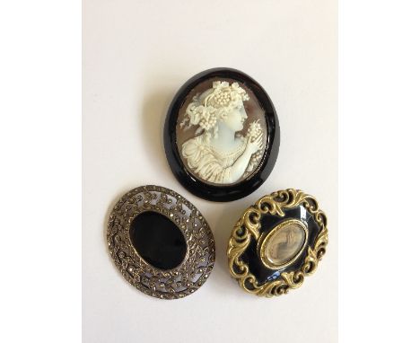 A large 19th century Cameo brooch depicting a portrait of a young Bacchanalian female figure together with two Victorian mour