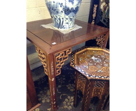 A Chinese hardwood square shaped table with inlaid mother of pearl floral decoration to legs and carved bracket supports.