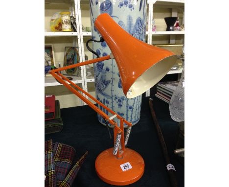 An orange Herbert Terry and sons angle poise lamp