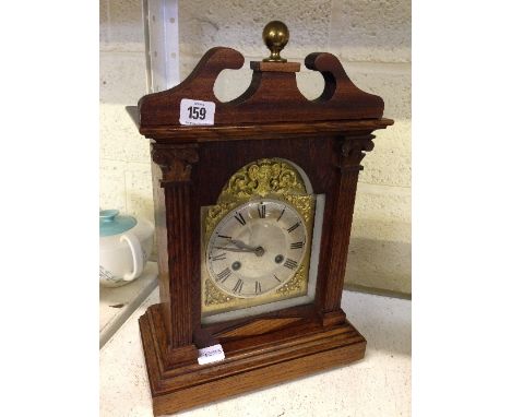 An oak cased chiming mantle clock.