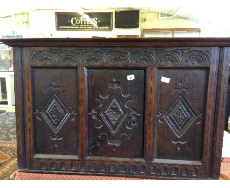 A 17th century style carved oak cupboard with central panel door.