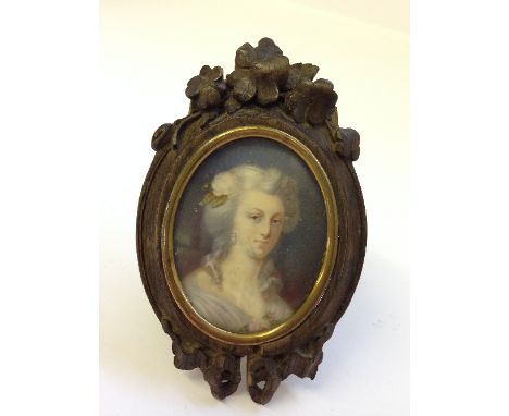 A 19th century miniature: portrait of a Lady in period costume in carved Bavarian wood frame.
(R6)