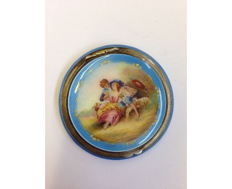 An early 20th century Continental silver and enamel powder compact with internal mirror, the lid decorated with a Courting Co