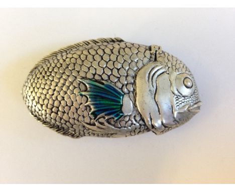 A replica silver metal and enamel fish shaped Vesta case.