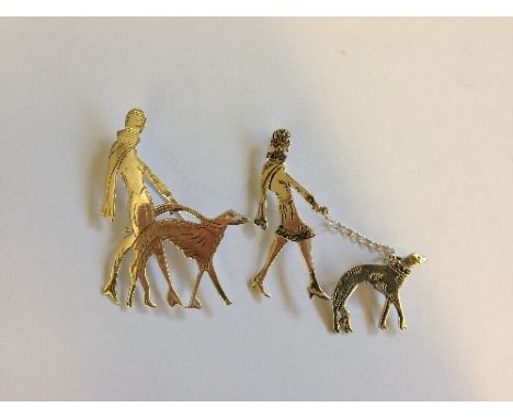 Two Art Deco style silver brooches modelled as ladies walking dogs.