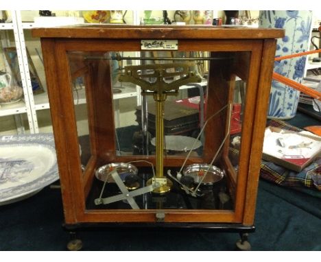 An early 20th century glass cased set of Oertling laboratory balance scales.