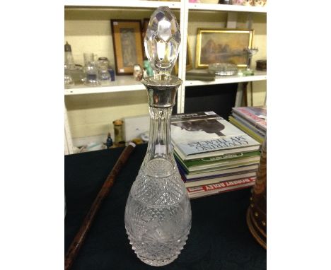 An early 20th century cut glass mallet shaped decanter with etched stylised floral decoration and silver collar.