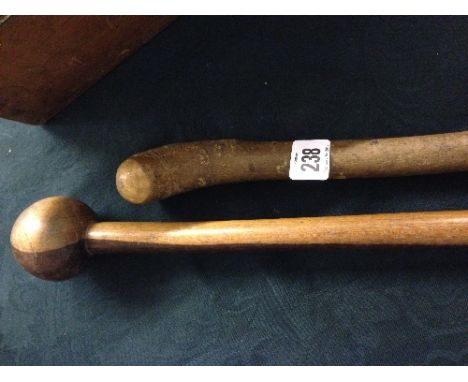 A hardwood knobkerrie native walking stick together with another.