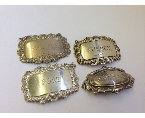 Four various silver decanter labels.