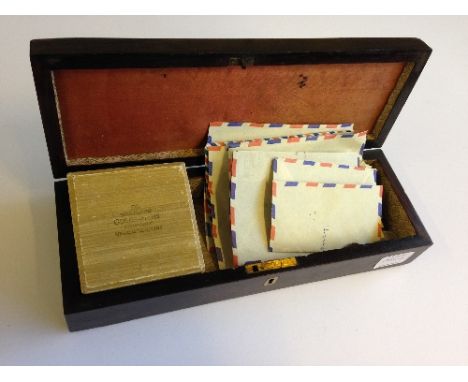 An early 20th century ivory inlaid cribbage board containing coins, foreign bank notes and a small quantity of costume jewell