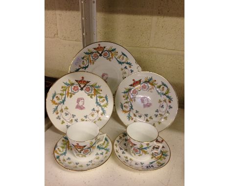 A Queen Victoria commemorative 1887 Jubilee pair of cups, saucers and side plates with matching cake plate, decorated with a 