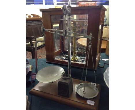 A set of chromed early 20th century balance scales together with a 4lb cast iron weight.