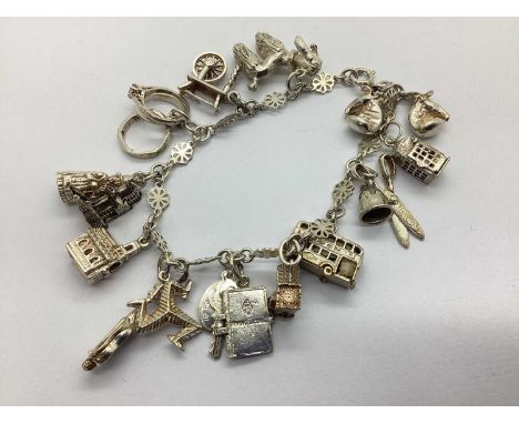 A Fancy Panel Link Charm Bracelet, suspending assorted novelty pendants, including articulated phone box, poodle, souvenir, g