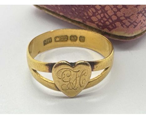 A 22ct Gold Heartshape Signet Ring, the heartshape centre panel engraved "GH", between bifurcated shoulders and wide band (fi