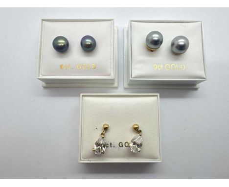 A Pair of Stone Set Drop Earrings, the ball shaped surmount suspending teardorp shape stone, three claw set, together with a 