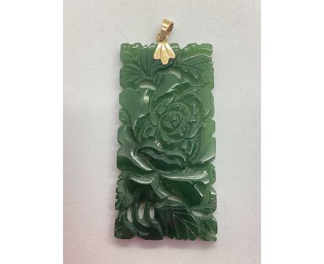 A Carved Green Hardstone Panel Pendant, of rectangular form with pierced flowerhead and foliage design, to fancy surmount sta