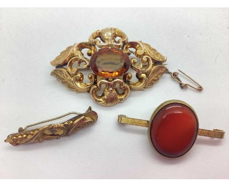 A Large Decorative Victorian Single Stone Brooch, oval collet set to the centre, within shaped scroll leaf design frame, with