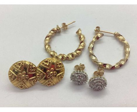 A Pair of Textured Circular Earstuds, stamped "375" to butterfly back, a pair of allover claw set cluster style earrings, and